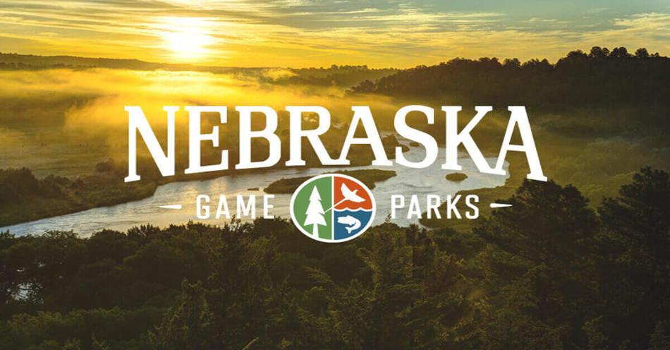 Nebraska Game and Parks Logo With a senery of a river and a sunrise in the background.